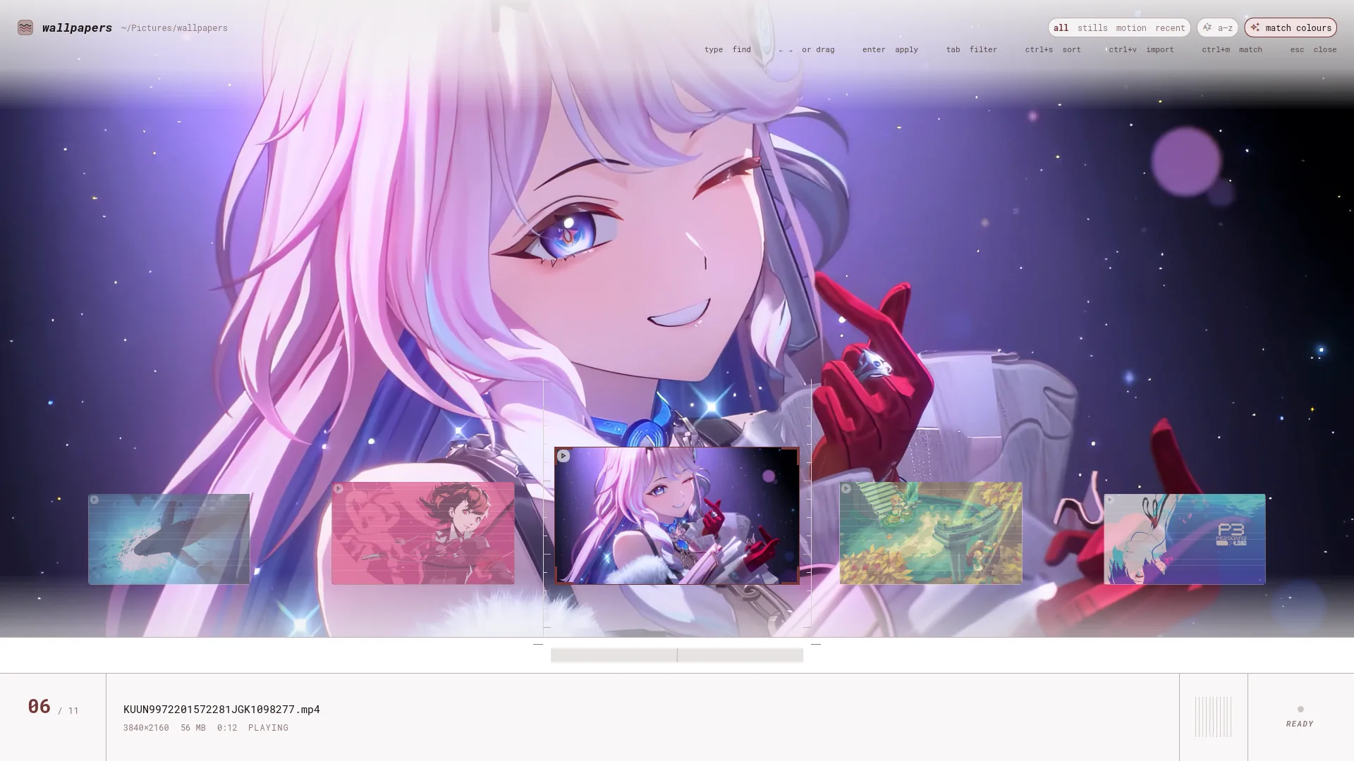 The wallpaper picker: one wallpaper filling the screen, a rail of frames along the bottom, and a plate reading the file name, resolution, size and duration